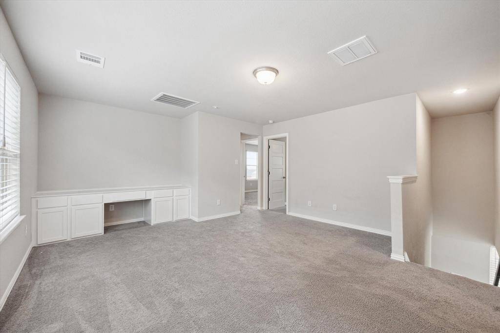 GAMEROOM WITH BUILT-IN DESK AND ENTERTAINMENT AREA.