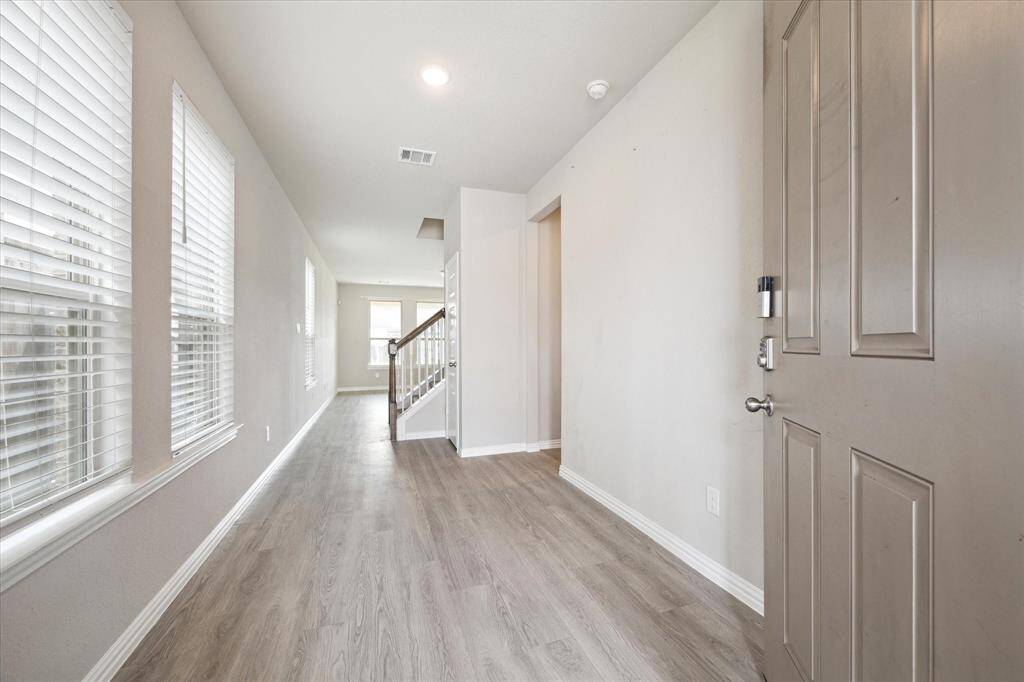 ENTRY WITH LUXURY VINYL PLANK FLOORS THAT FLOW THROUGHOUT THE LIVING AREAS.