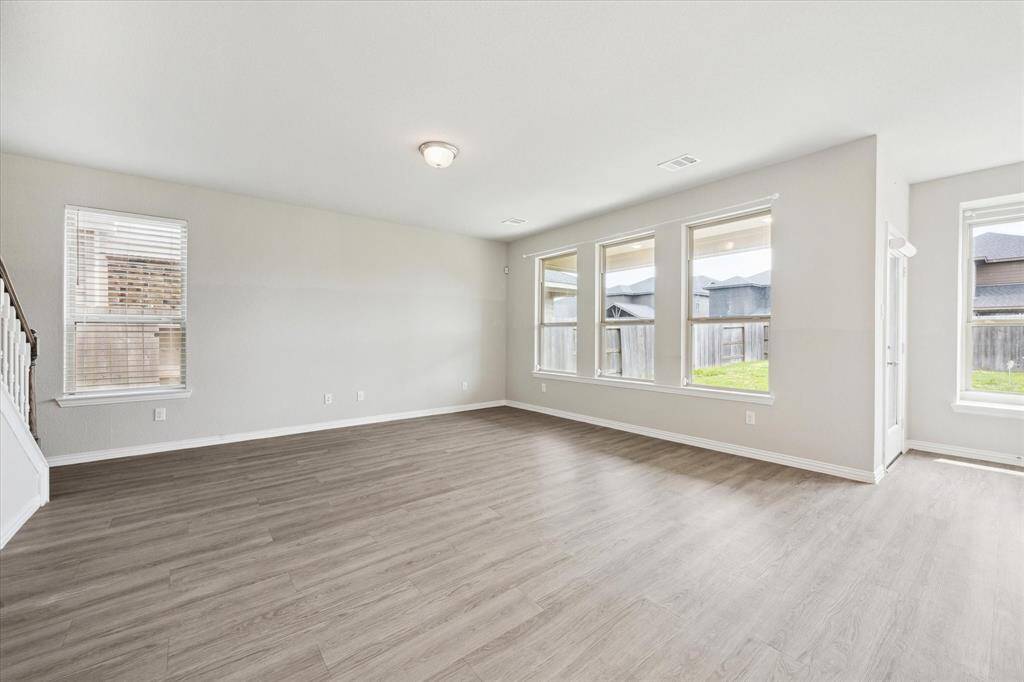 LARGE PORTRAIT WINDOWS OVERLOOK THE BACKYARD.