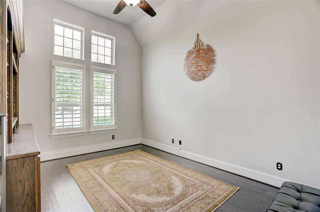 Bright and airy, this flexible space features high ceilings, shuttered windows, hardwood floors, and a built-in bookcase. It's perfect as a study, home office, or reading nook.