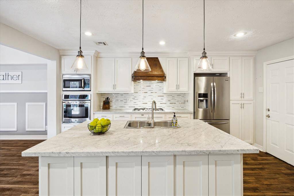 Gorgeous oversized, chef-inspired marble island blends functionality with timeless elegance.