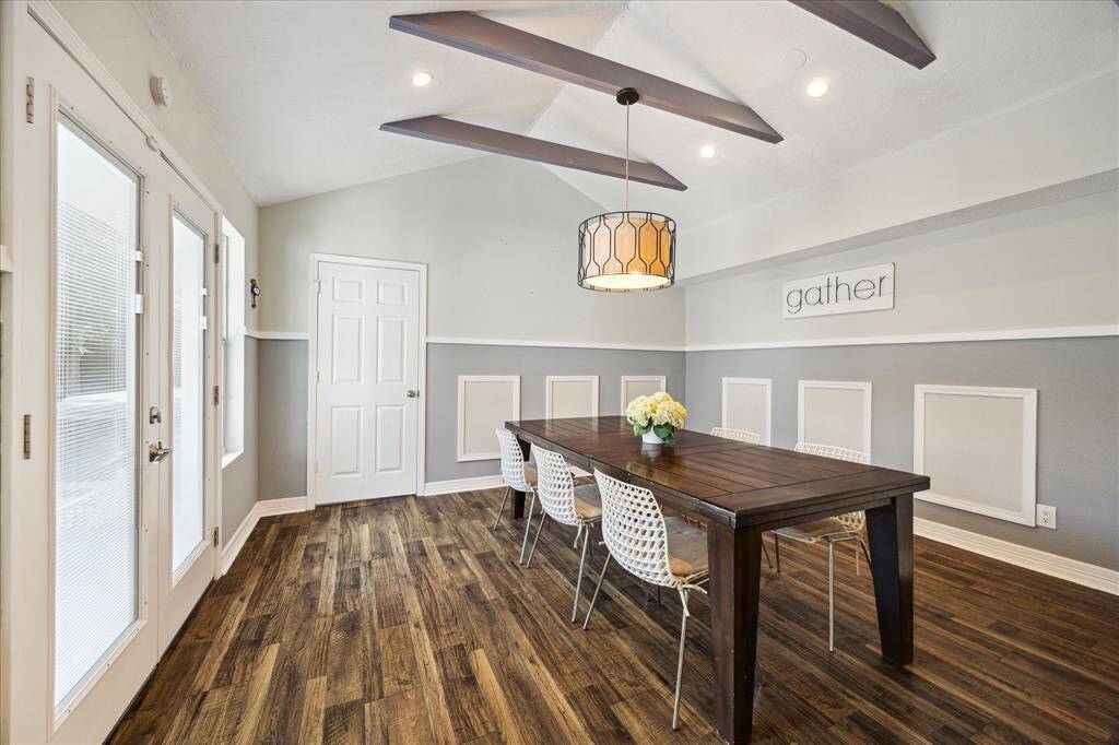 Flooded with natural light, the spacious dining room features vaulted ceilings and French doors leading to the backyard.