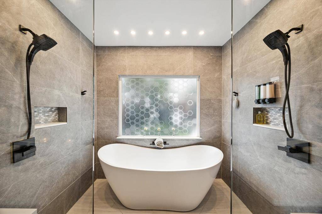 The spacious shower is equipped with dual shower heads.