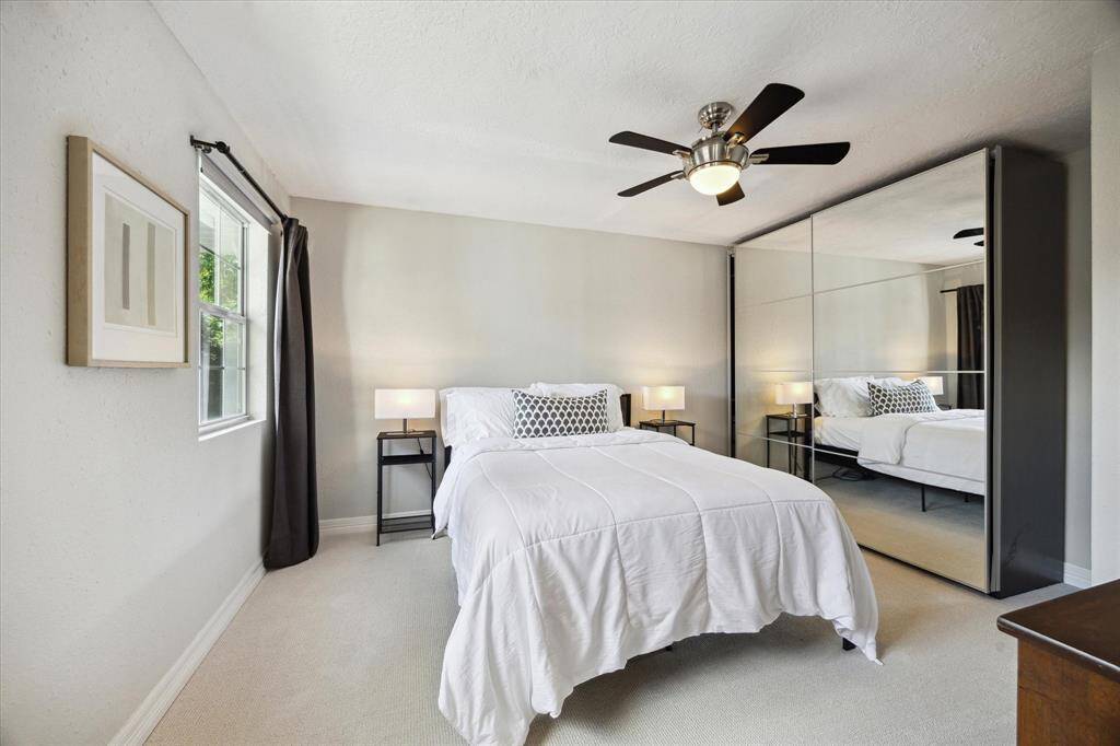 Another view of Bedroom 4 with a window overlooking the backyard.