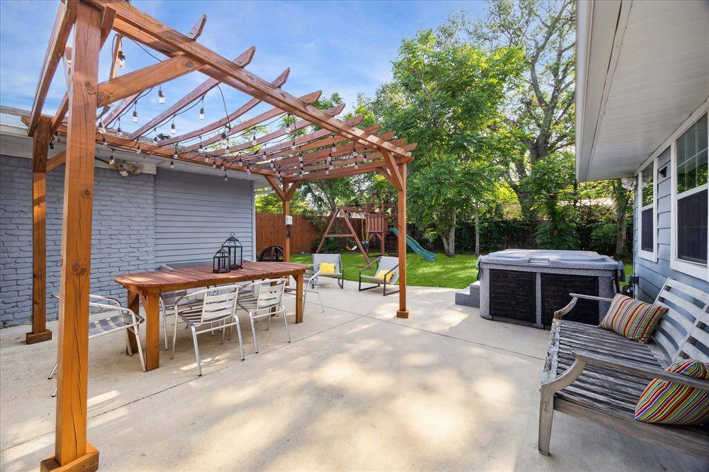 Perfect for entertaining or relaxing, the spacious backyard patio features a Jacuzzi hot tub and pergola.