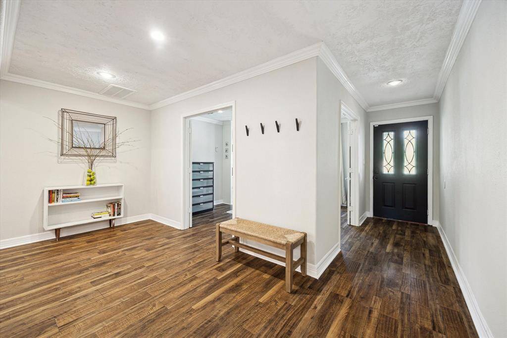 Front hallway opens to a home office and large living room.