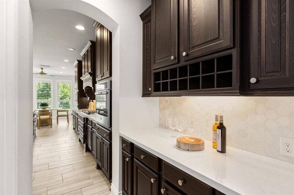 Butlers pantry conveniently located between formal dining and kitchen.