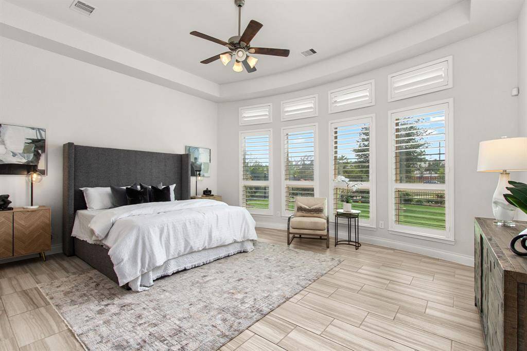 Primary bedroom with curved wall of windows, and great natural light!