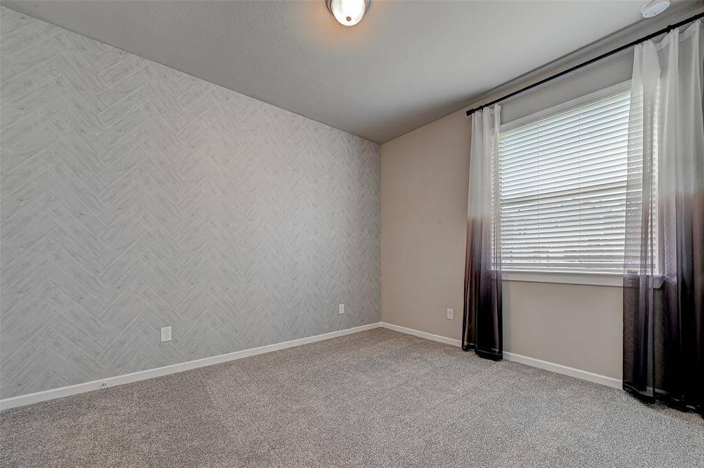 Secondary bedroom with tile design wall