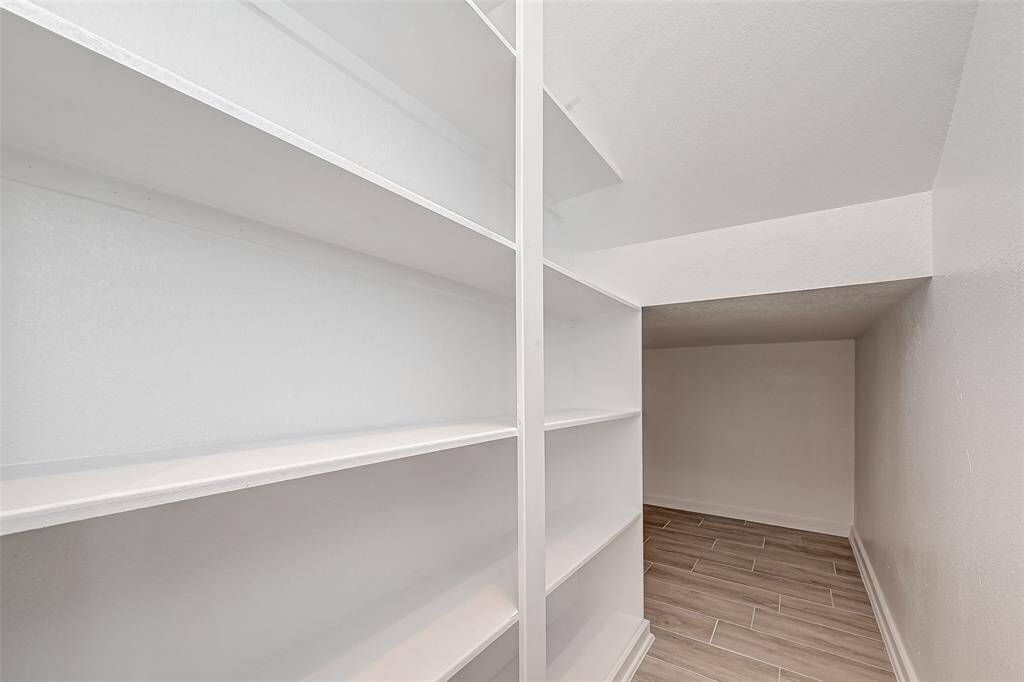 Under stairs storage space with shelving