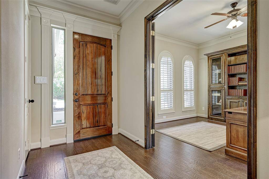 Detailed millwork throughout, hardwood flooring, and plantation shutters