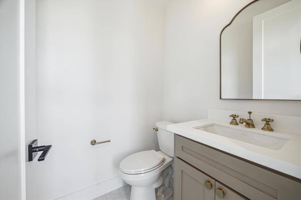 This powder bath will make your guests swoon! Elegant hardware and framed mirror bring plenty of personality and style