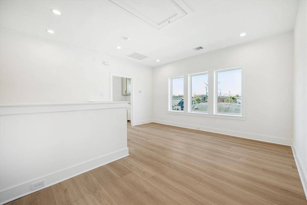 Additional view of second floor flex space and 3 casement windows, doorway center leads to primary retreat