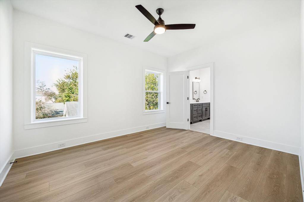 Bedroom offers a walk-in closet, modern ceiling fan and access to the jack and jill bath