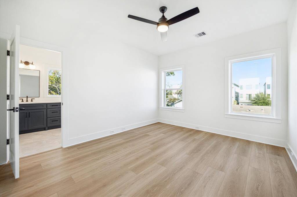 Bedroom offers a walk-in closet, modern ceiling fan and access to the jack and jill bath
