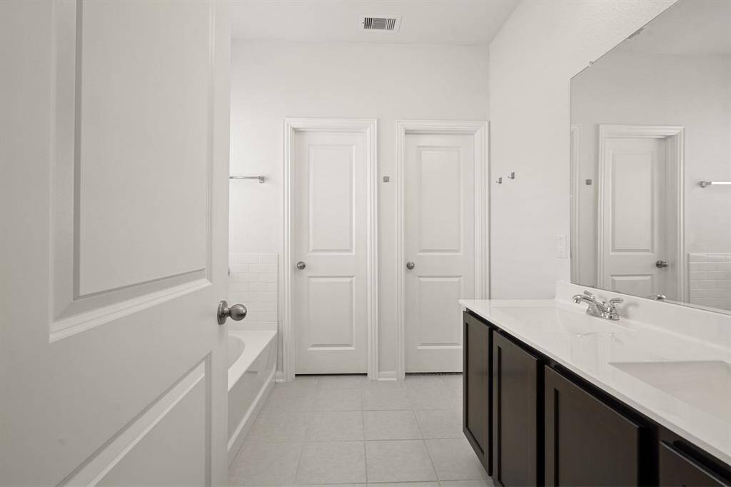 Primary Bathroom with a walk-in closet.