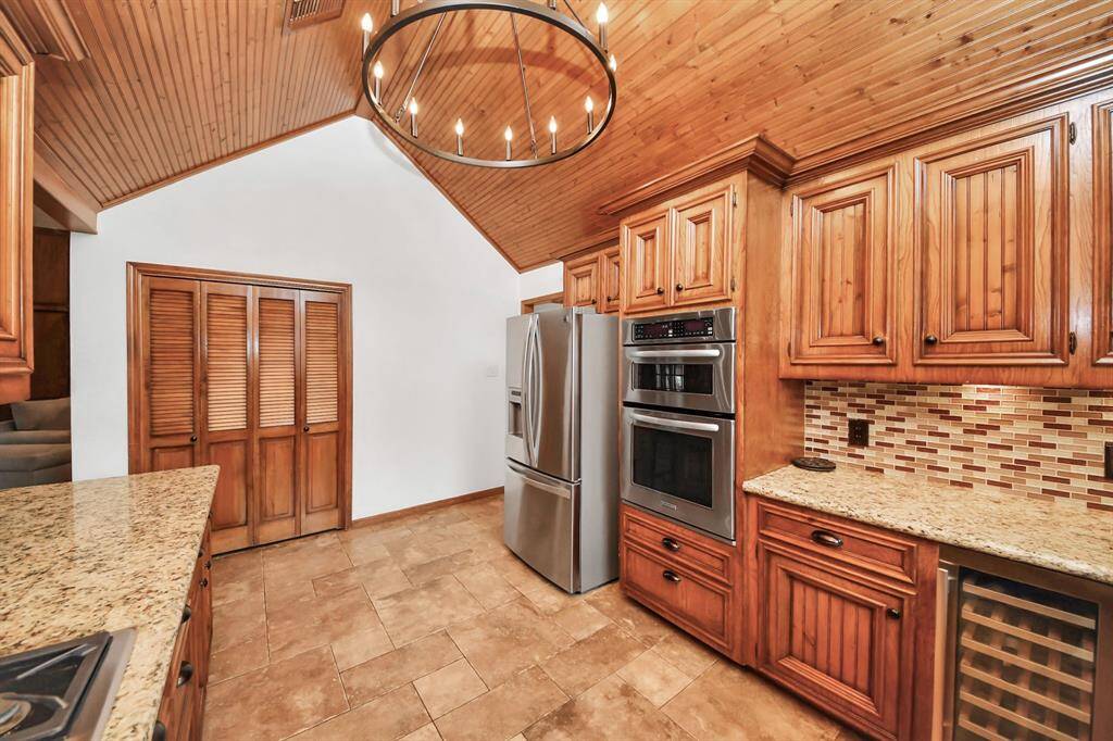 With granite countertops, lovely backsplash areas, abundant cabinetry with under-cabinet lighting, stainles steel appliances and a dedicated wine refigerator - this kitchen has it all!