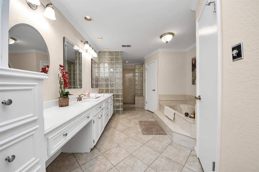 The primary suite bathroom is just lovely...featuring a spacious walk-in shower, separate soaking tub, dual sinks and two walk-in closets!