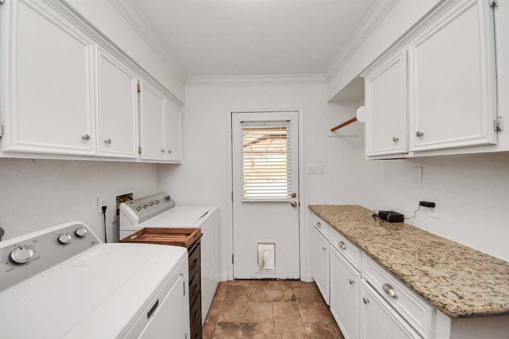 The laundry room offers direct access to the covered patio area at the rear of the home, and has an abundance of storage and countertop space!