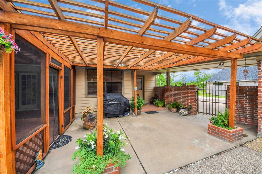 Adjacent to the screened porch is another lovely, trellised patio area - offering the perfect spot for grilling adventures!