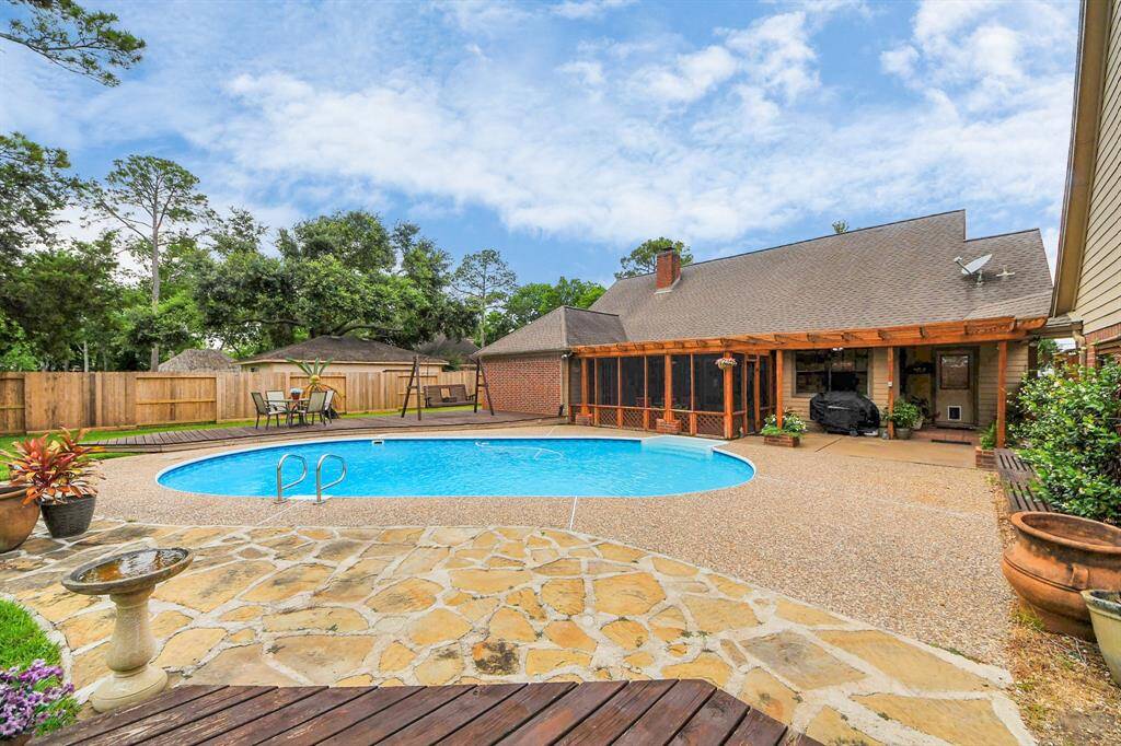 The backyard features a lovely pool with extensive decking and seating areas!
