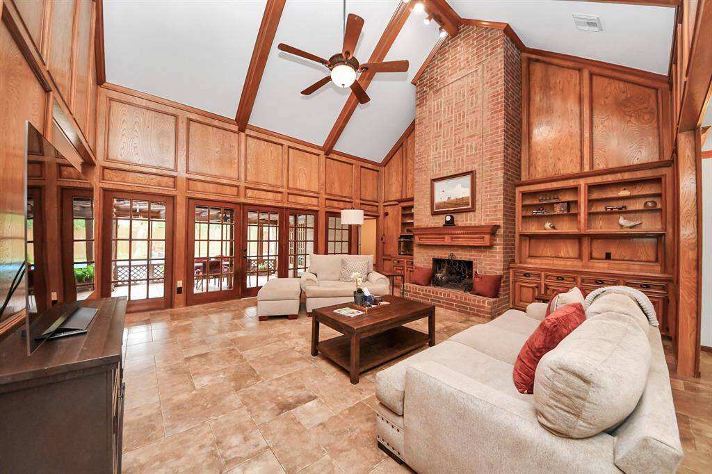 The spacious living room offers direct French-door access to the beautiful screened in porch!