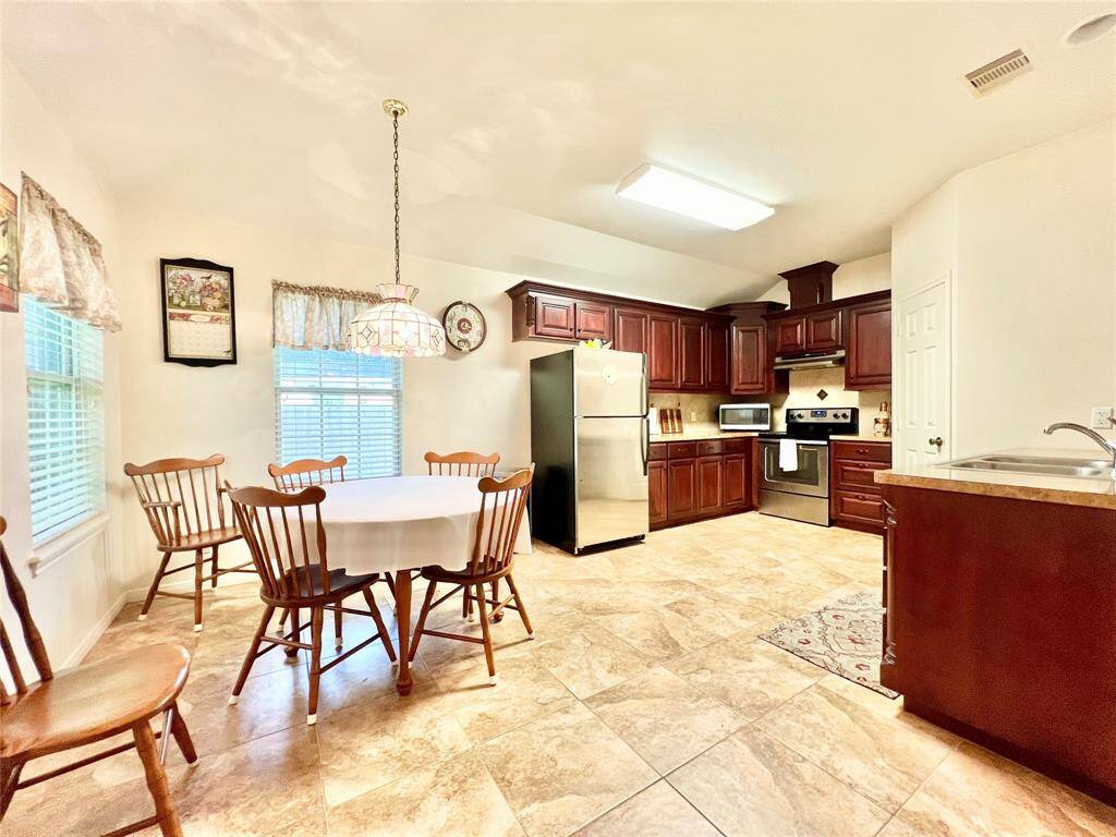 Lots of open space and custom cabinets, matching tile backsplash and flooring, large walk-in pantry on right, soft close cabinets and drawers, pot and pan drawers too.