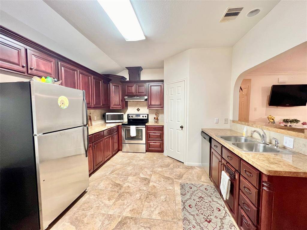 Another great view of the custom cabinets and opening toward family room.