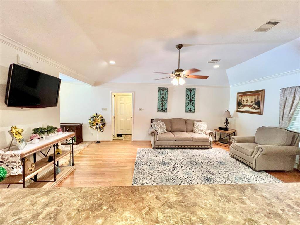 View of Family Room from inside of Kitchen overlooking the breakfast bar at the bottom of the photo