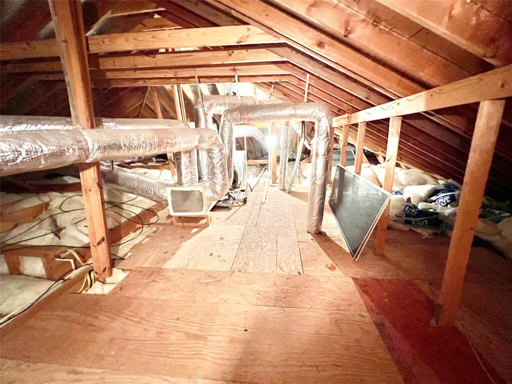 Large solid decking over garage.  Clean pan for hvac unit, reflective insulation for roof and lots of batting insulation.