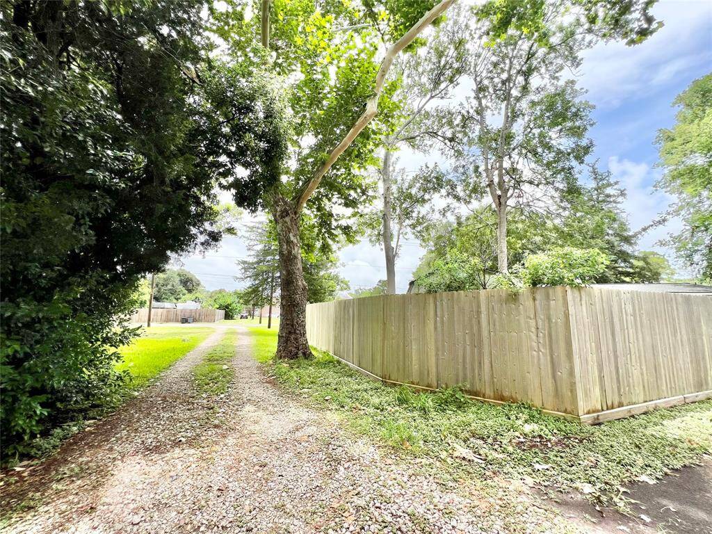 Private alleyway entrance to the garage apartment, neighbor has a tall privacy fence in place on his land.