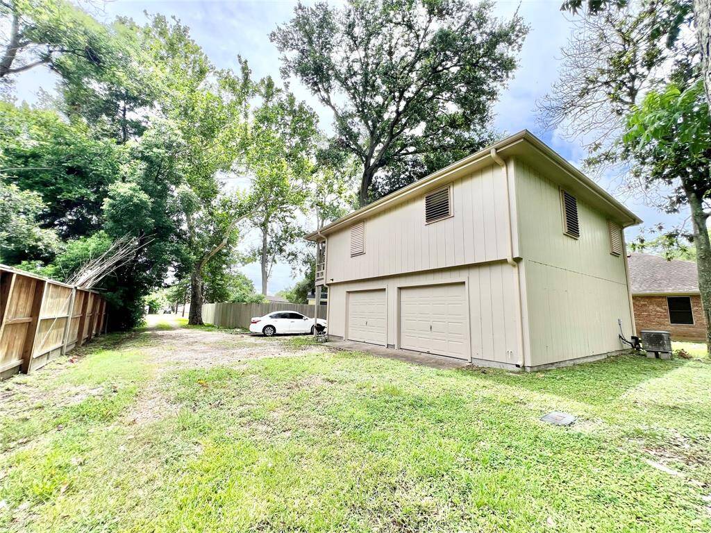 View of the back of the garage apartment, on the right side is the oversized one car garage that can be used for additional storage, he or she shed or workshop for owner.