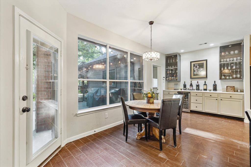 The breakfast area showcases the chef's kitchen, full bar, and extended patio.