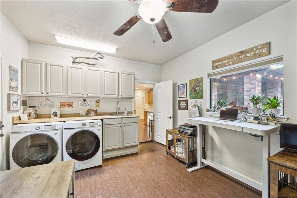 The in-home laundry room offers plenty of storage and ample cabinetry, with a convenient countertop space. This room offers a direct connection and private entryway to the additional garage flex space and exterior patio.