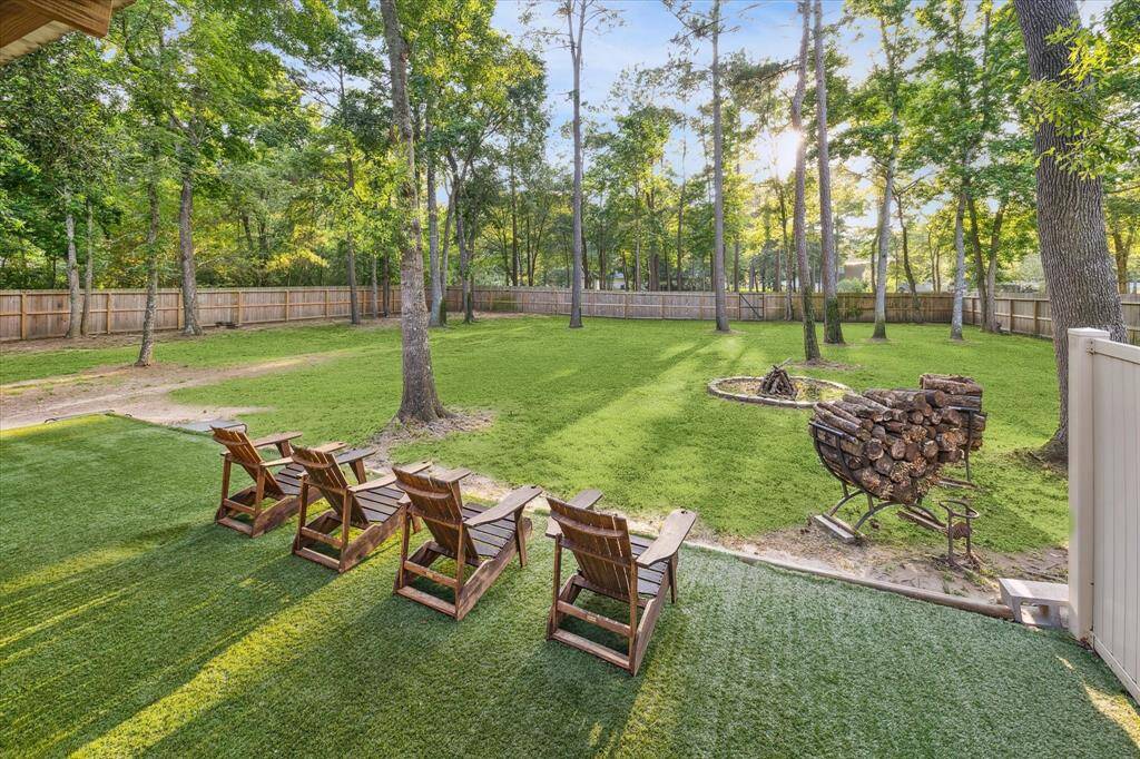 Experience the very best of outdoor living featuring mature trees, a cozy fire pit area, and artificial turf area, all enclosed by a privacy fence. The fence entryway allows for direct, private lake access at your leisure.
