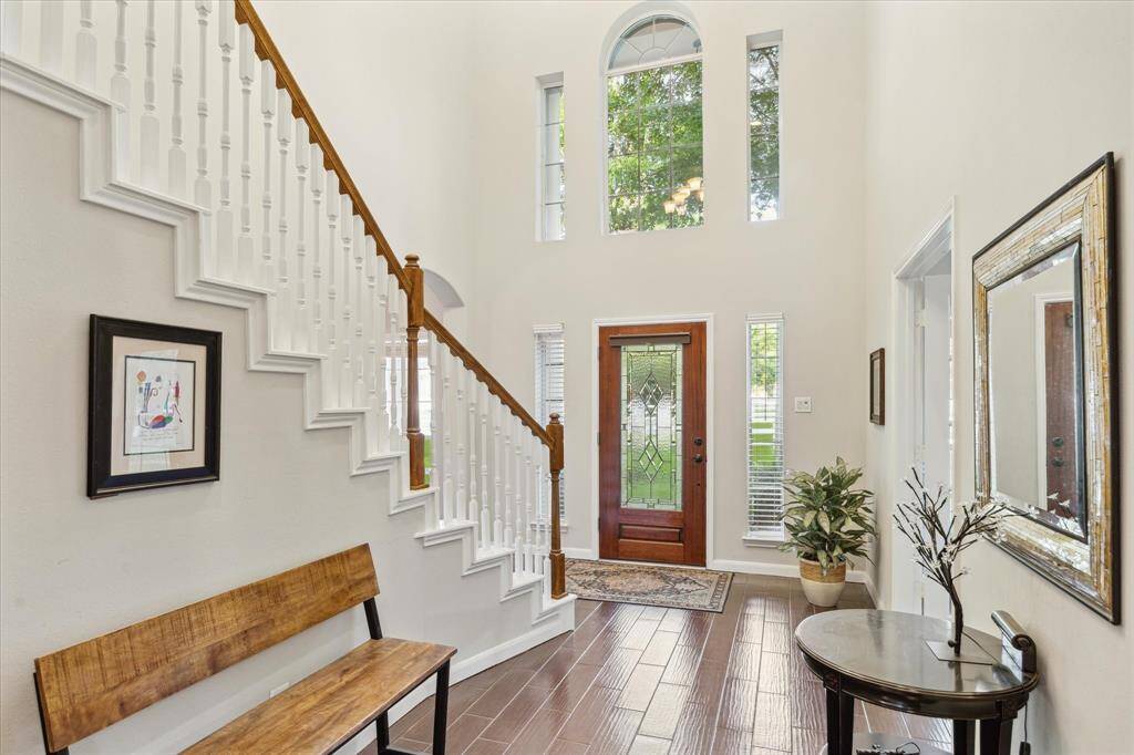 Experience a grand welcome with the foyer's soaring ceilings, abundant natural light, and elegant custom paint.
