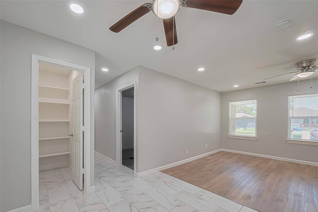 A generous pantry located next to the dining area features built-in shelving to keep everything organized and accessible.