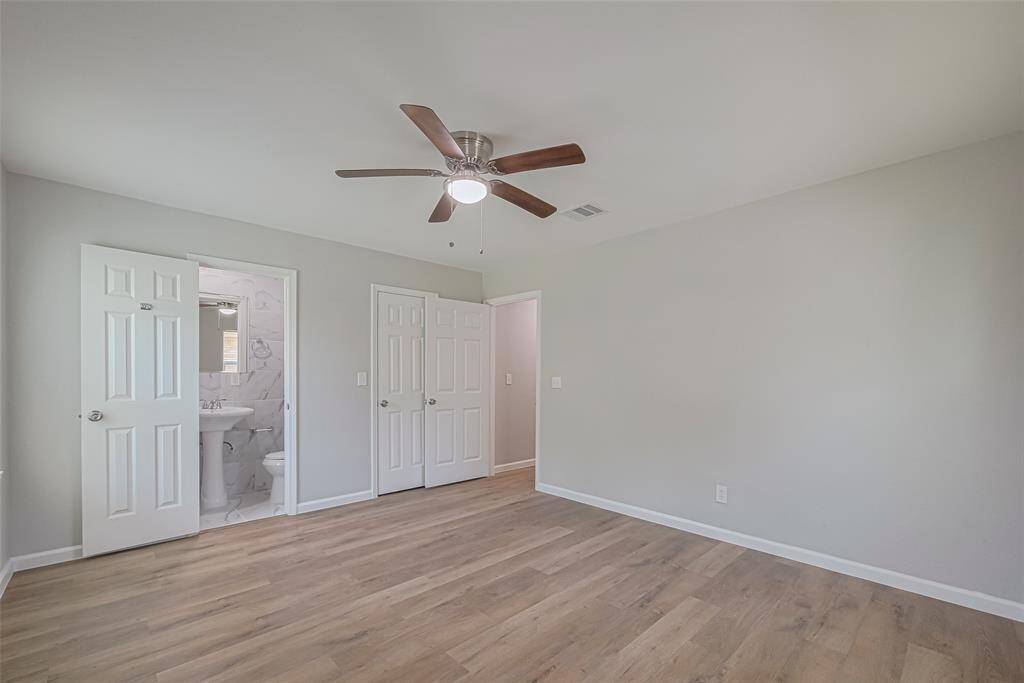 This restful primary bedroom has an en suite bath, ceiling fan, and ample room to personalize with your favorite furnishings.