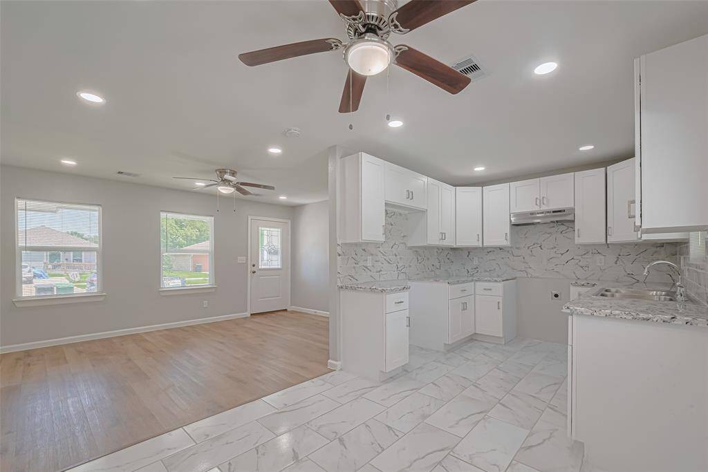 This open-concept layout showcases the flow between the kitchen and living area, ideal for both relaxing and entertaining.