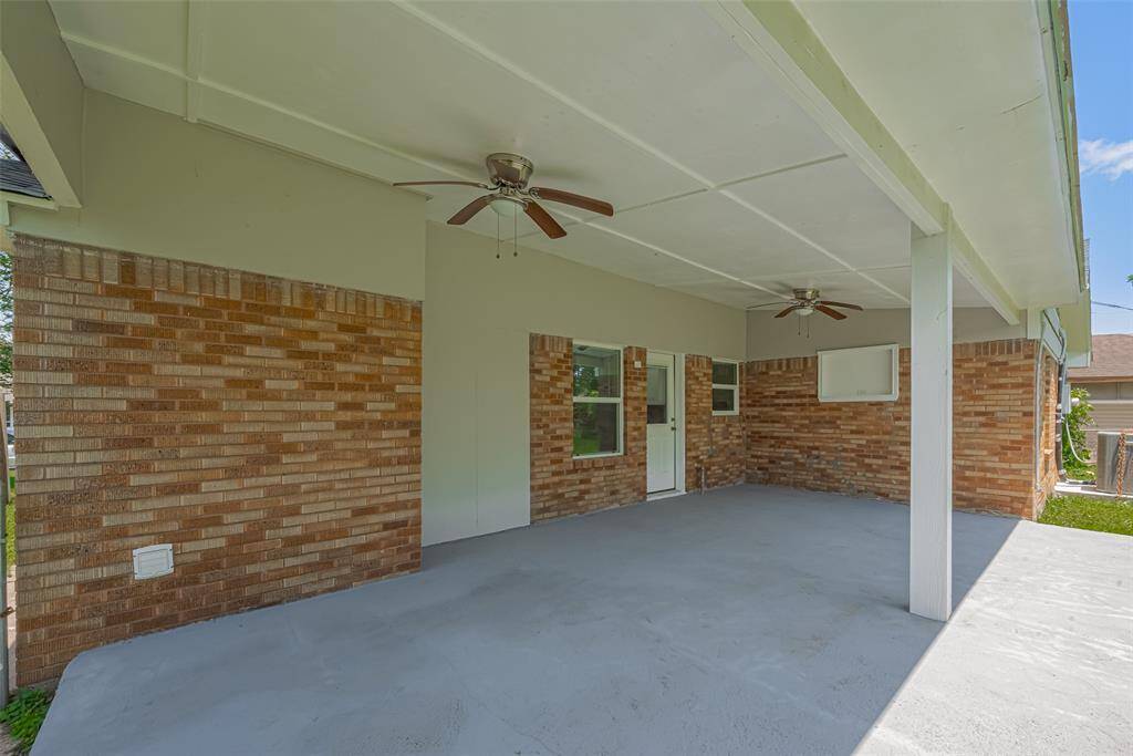 The rear patio spans a generous portion of the backyard, offering endless potential for lounging, dining, or entertaining outdoors.