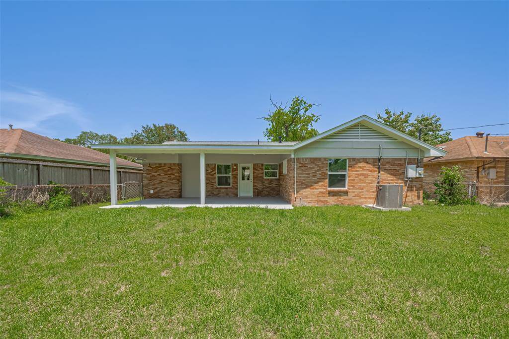 A centered view highlights the large patio and full stretch of backyard greenery, ideal for outdoor living.