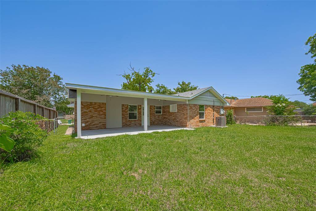 From another angle, the backyard's generous size and verdant condition are evident — plenty of space to roam or garden.