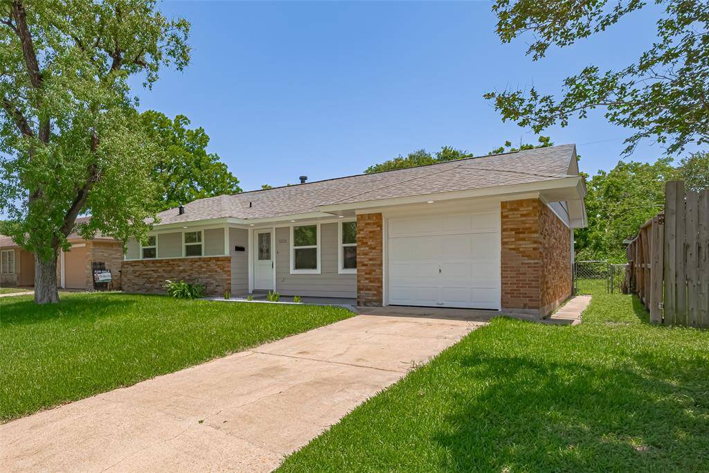 The front view of the home features the attached garage and paved driveway, framed by fresh landscaping.