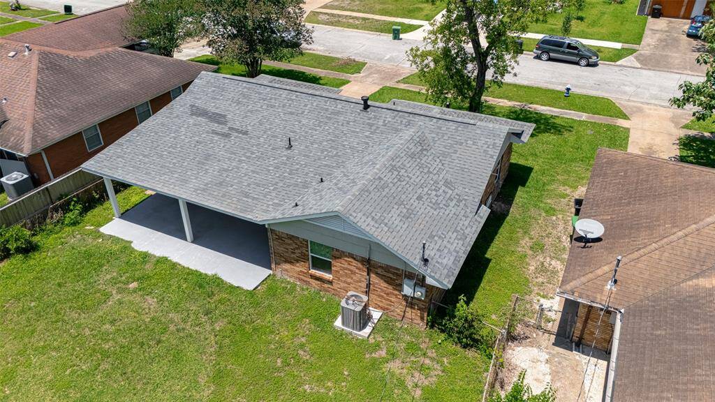 An aerial perspective from the rear shows the patio, backyard expanse, and front approach — all on a well-positioned lot.