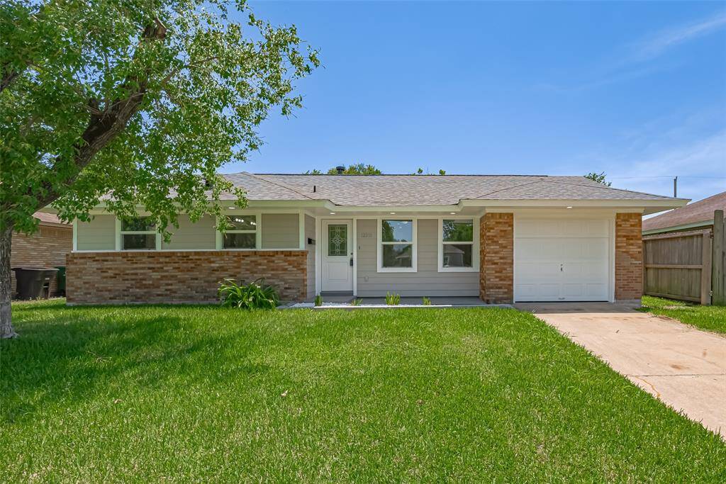 Fresh curb appeal is on full display with the neat front lawn, covered entryway, and a tasteful combination of brick and cement board siding.