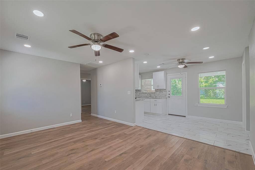 Enjoy a natural transition from the living room to the dining area, with a half wall partially separating the kitchen for visual interest and openness.