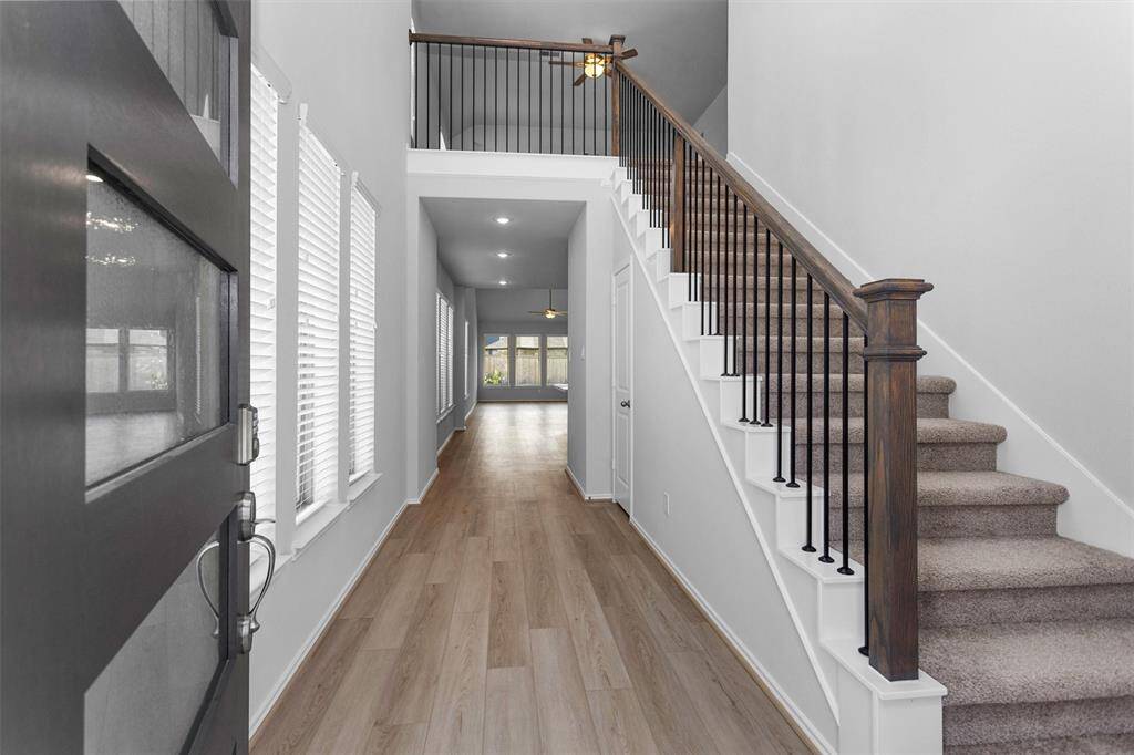 Step inside and be greeted by an open floorplan bathed in natural light, showcasing large windows and light finishes throughout!