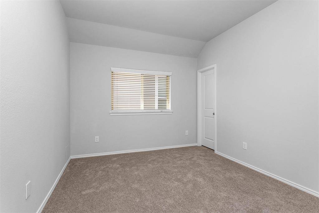 Bedroom #4 boasts a large window and neutral paint.