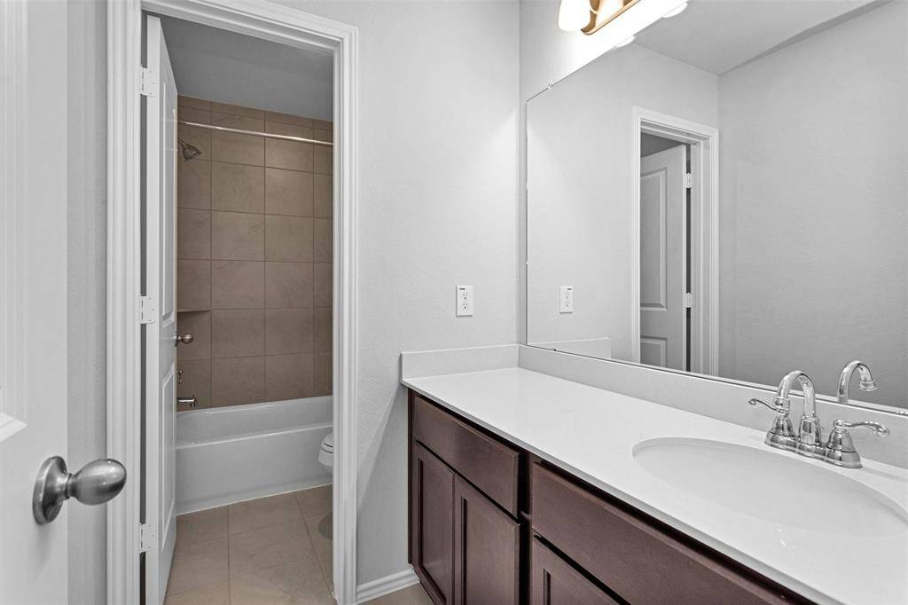 Bathroom #4 has a separate, large vanity area and a tub/shower combination.