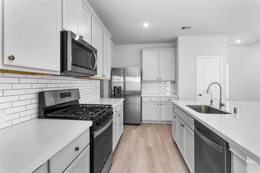 The modern Kitchen features a stainless steel sink and appliances!